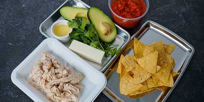 Chilaquiles Chicken Recipe ingredients prepared before cooking and portioned on trays