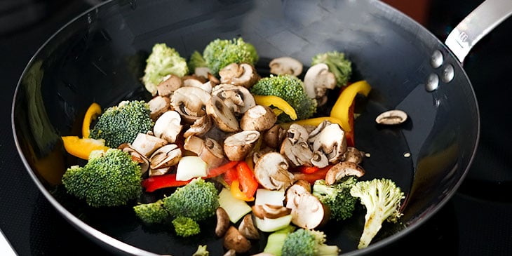stir frying vegetables in wok